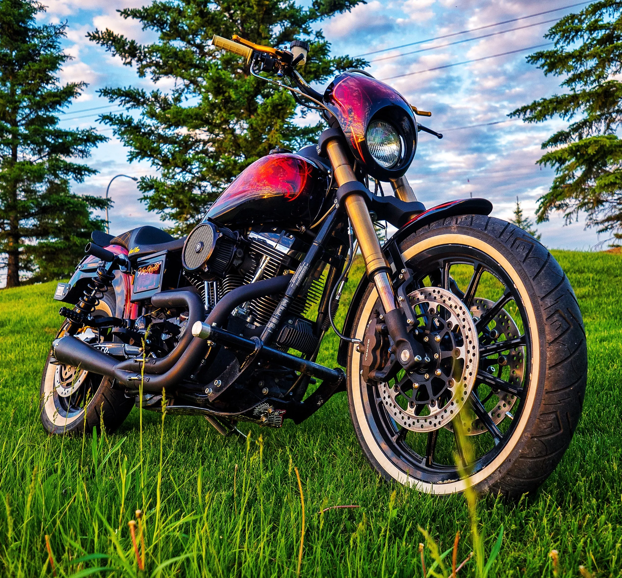 Custom Harley-Davidson Dyna in the grass at sunset