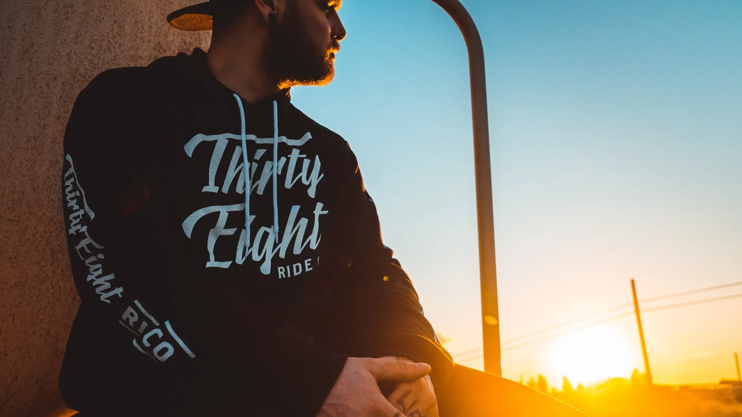 Lee Stuart in a Thirty Eight Ride Co hoodie at sunset
