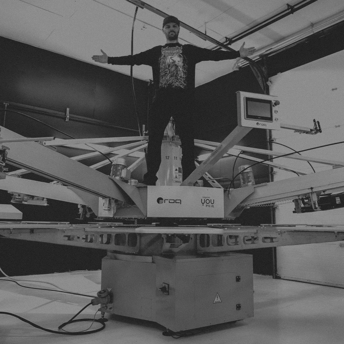 Lee standing on top of the automatic press with his arms out