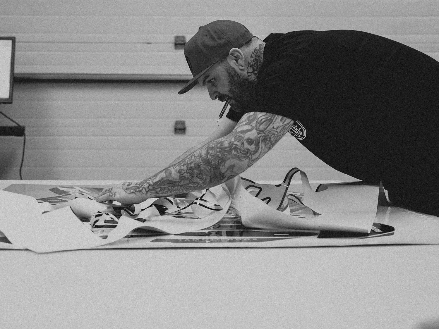 Lee laying out printed transfer sheets across the bench